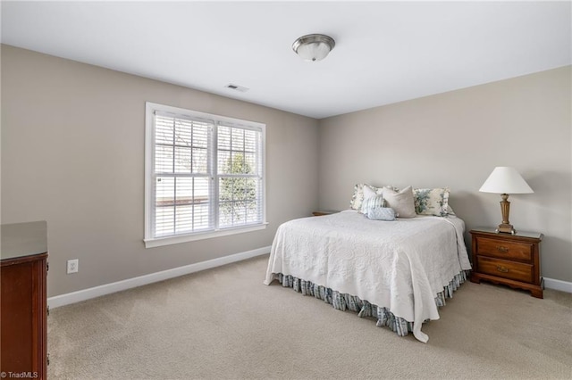 carpeted bedroom with baseboards and visible vents