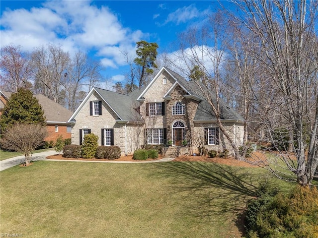 traditional-style home with a front yard and brick siding