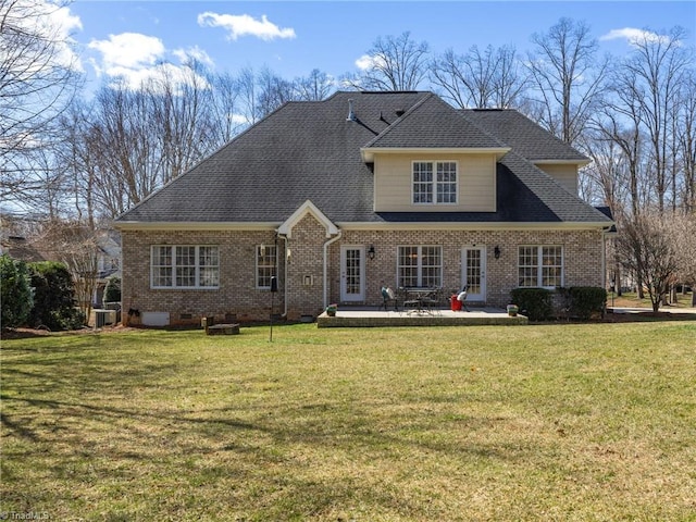 view of front facade with crawl space, brick siding, a patio, and a front lawn