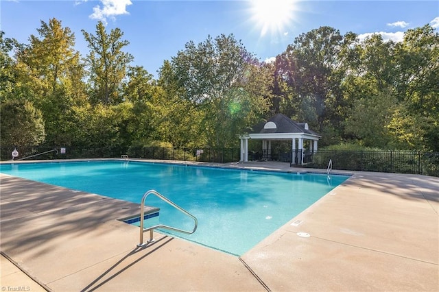 community pool featuring a patio area, fence, and a gazebo