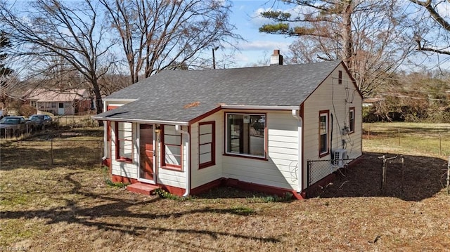 exterior space featuring a yard and central air condition unit