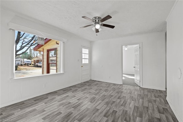 spare room featuring a textured ceiling, hardwood / wood-style floors, and ceiling fan