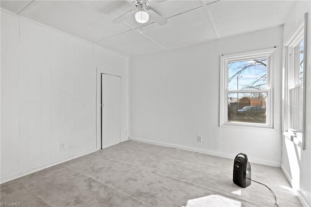 unfurnished room featuring ceiling fan and light colored carpet