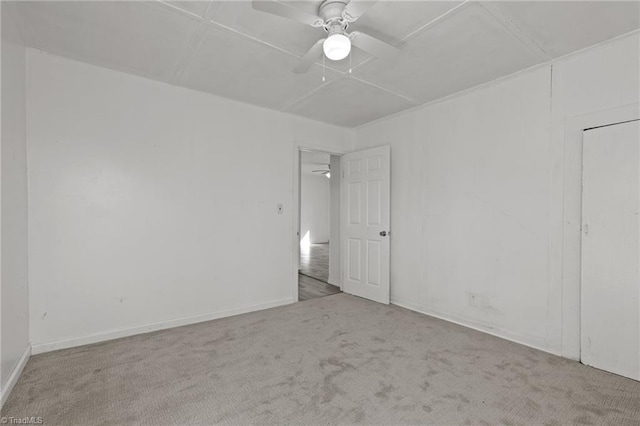 unfurnished room featuring ceiling fan and light colored carpet