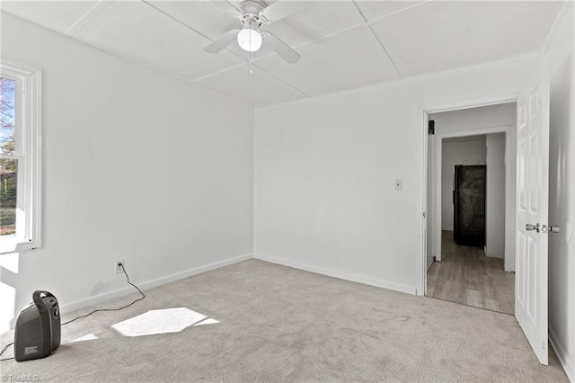 unfurnished room featuring light colored carpet and ceiling fan