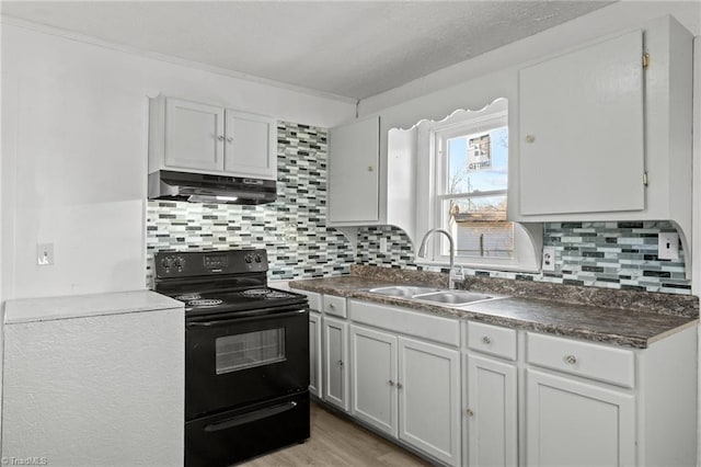 kitchen featuring sink, electric range, and white cabinets