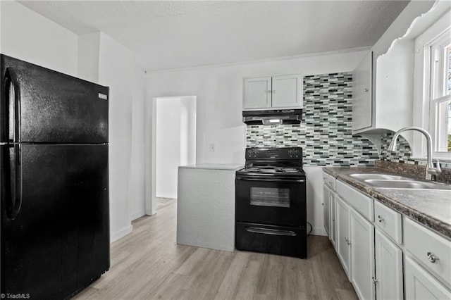 kitchen with black appliances, range hood, sink, backsplash, and white cabinets