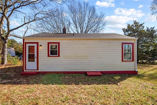 view of outbuilding featuring a lawn