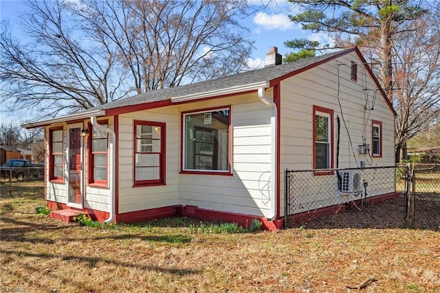 view of outbuilding with ac unit and a lawn