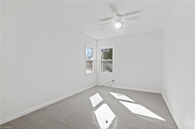 empty room with ceiling fan and carpet flooring