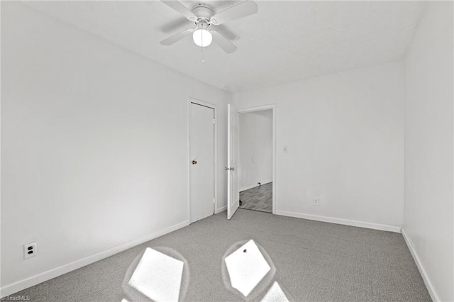 unfurnished bedroom with ceiling fan and carpet floors