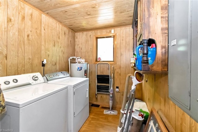 140 Blue Heron Ln, Wilkesboro, NC 28697 - laundry area with wooden ceiling, washer and clothes dryer, wooden walls, water heater, and light wood-style flooring