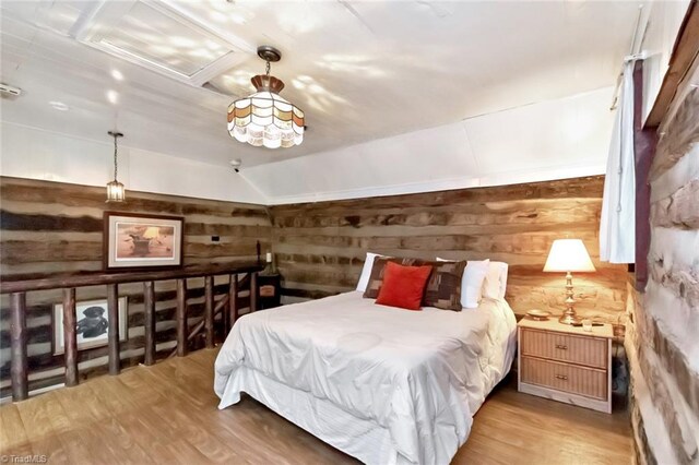 140 Blue Heron Ln, Wilkesboro, NC 28697 - bedroom with wooden walls, light wood-style floors, and lofted ceiling