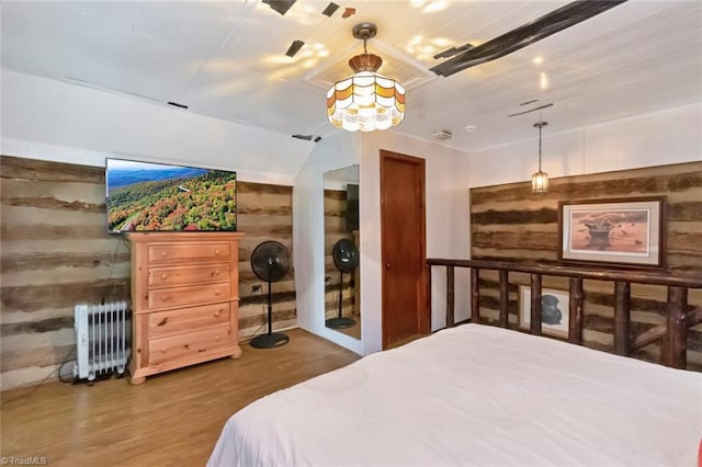 140 Blue Heron Ln, Wilkesboro, NC 28697 - bedroom with radiator heating unit, wood walls, and wood finished floors