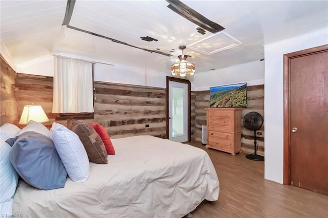 140 Blue Heron Ln, Wilkesboro, NC 28697 - bedroom with lofted ceiling, wooden walls, and wood finished floors