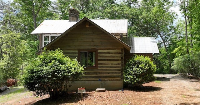 140 Blue Heron Ln, Wilkesboro, NC 28697 - view of property exterior with a chimney and metal roof