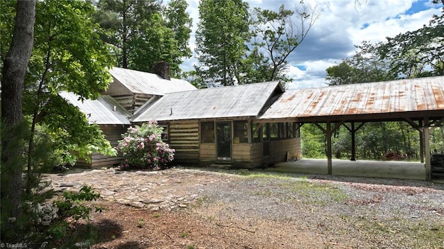 140 Blue Heron Ln, Wilkesboro, NC 28697 - view of front of property with dirt driveway, metal roof, a chimney, and an attached carport