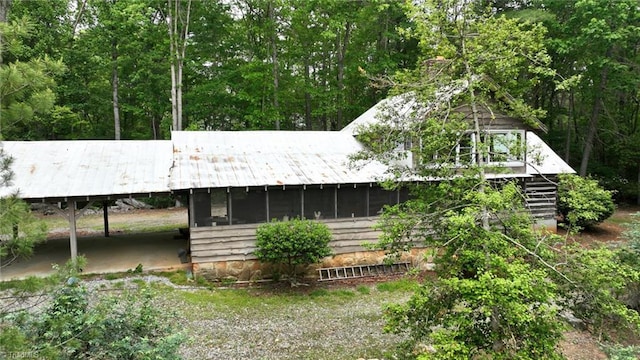 140 Blue Heron Ln, Wilkesboro, NC 28697 - rear view of house with metal roof, a sunroom, and stairs