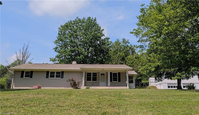 single story home with covered porch, a chimney, and a front lawn