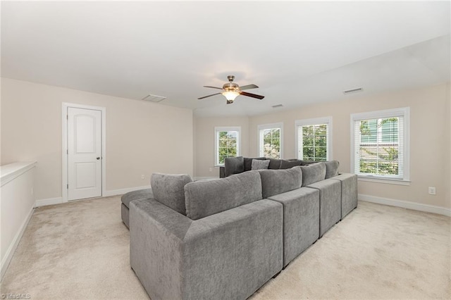 carpeted living room featuring ceiling fan