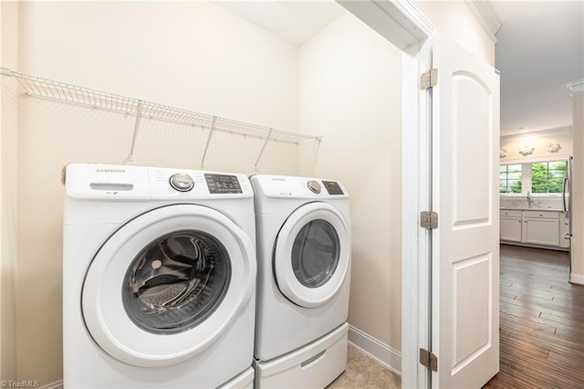 washroom featuring hardwood / wood-style flooring, sink, and washer and dryer