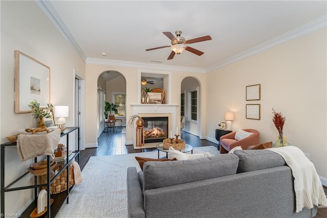 living room featuring ornamental molding, dark hardwood / wood-style floors, and ceiling fan