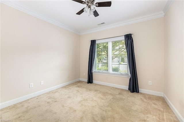 carpeted spare room with ceiling fan and ornamental molding