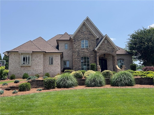 6792 Meadow View Dr, Summerfield, NC 27358 - view of front of home featuring a front yard, brick siding, and roof with shingles