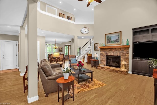 6122 Olde Fields Way, Pfafftown, NC 27040 - living room with a ceiling fan, stairs, ornamental molding, light wood-type flooring, and a fireplace