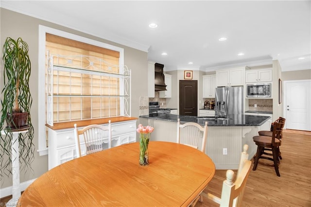 6122 Olde Fields Way, Pfafftown, NC 27040 - dining space with ornamental molding, light wood-type flooring, recessed lighting, and baseboards