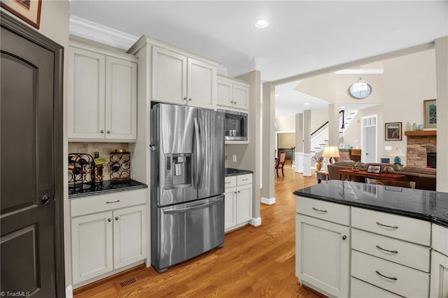 6122 Olde Fields Way, Pfafftown, NC 27040 - kitchen with appliances with stainless steel finishes, ornamental molding, light wood-type flooring, backsplash, and open floor plan