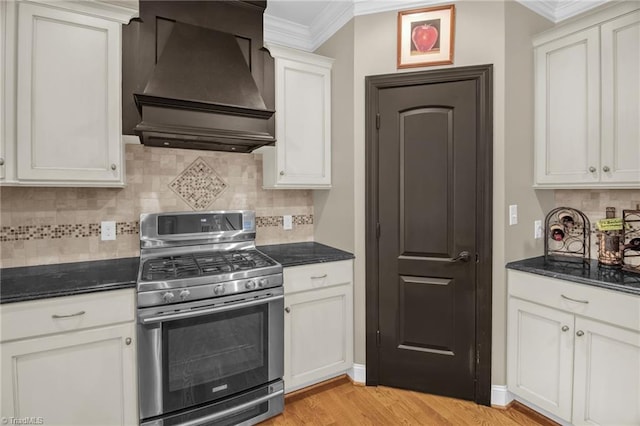 6122 Olde Fields Way, Pfafftown, NC 27040 - kitchen with stainless steel range with gas stovetop, custom range hood, crown molding, light wood-style floors, and decorative backsplash