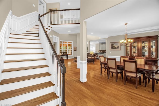 6122 Olde Fields Way, Pfafftown, NC 27040 - stairs featuring wood finished floors, a chandelier, and crown molding