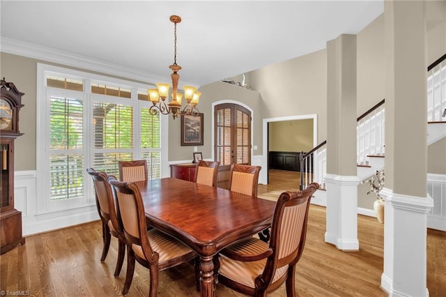 6122 Olde Fields Way, Pfafftown, NC 27040 - dining area featuring light wood-type flooring, french doors, a chandelier, stairs, and wainscoting