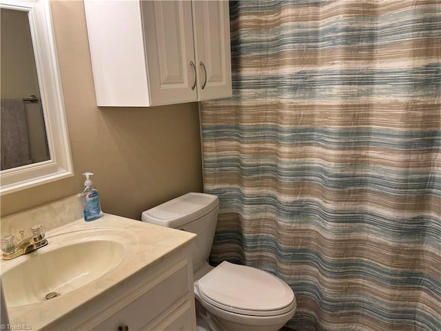 bathroom featuring toilet and vanity