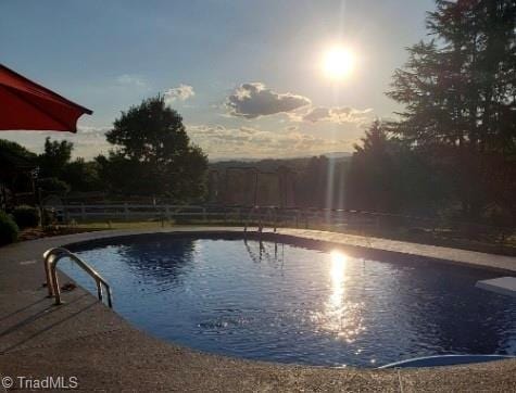 view of pool at dusk