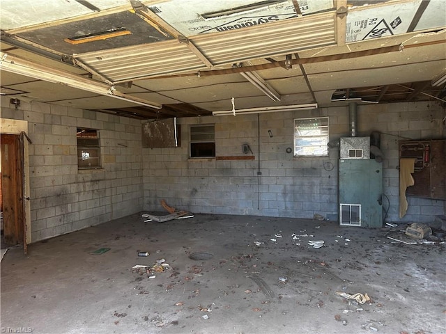 basement featuring concrete block wall and visible vents