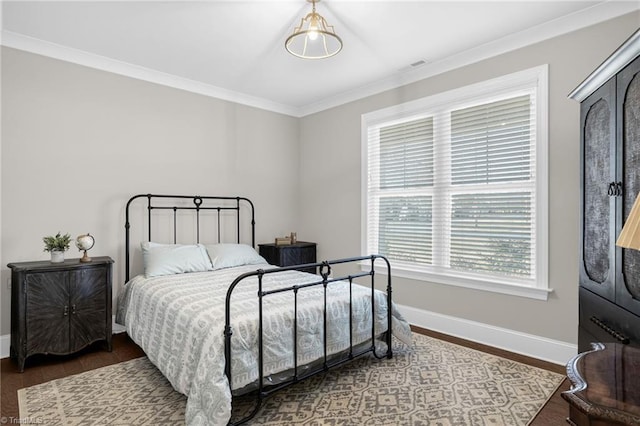 bedroom with crown molding and dark hardwood / wood-style floors