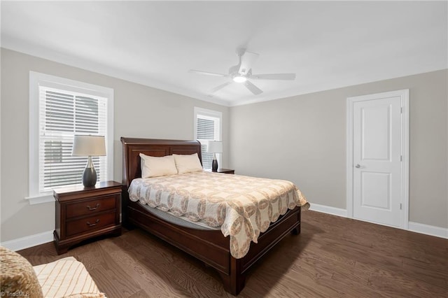 bedroom featuring ceiling fan, dark hardwood / wood-style flooring, and multiple windows