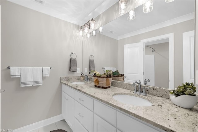 bathroom with vanity, ornamental molding, and tile patterned floors