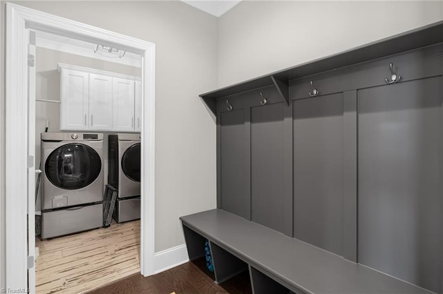 mudroom with dark hardwood / wood-style flooring and washer and dryer