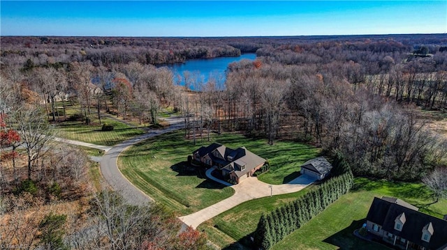 drone / aerial view featuring a forest view and a water view