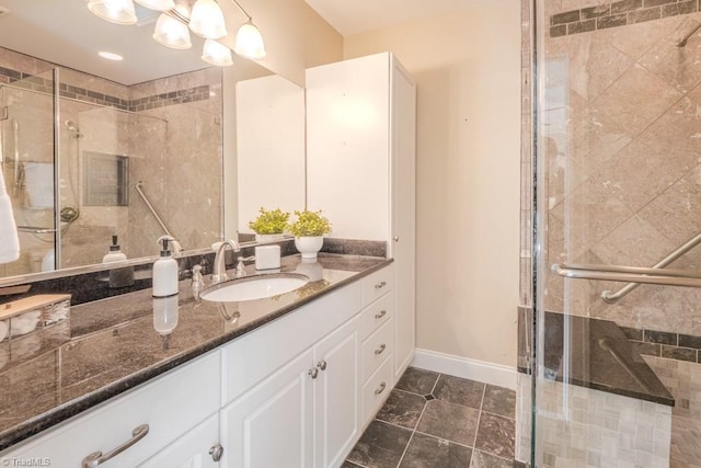 bathroom featuring a chandelier, vanity, and a shower with shower door