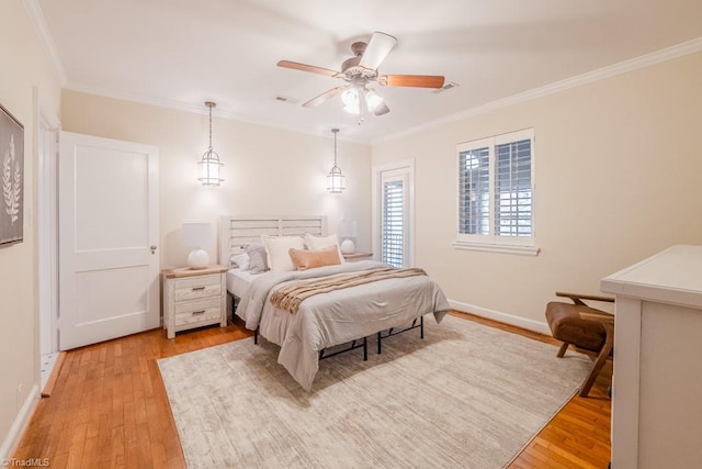 bedroom with crown molding, ceiling fan, and light wood-type flooring