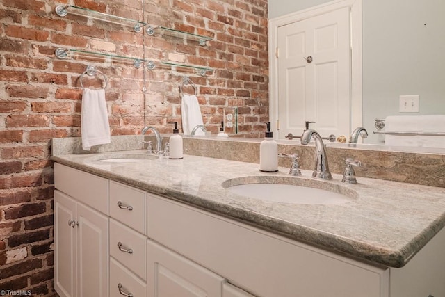 bathroom with brick wall and vanity