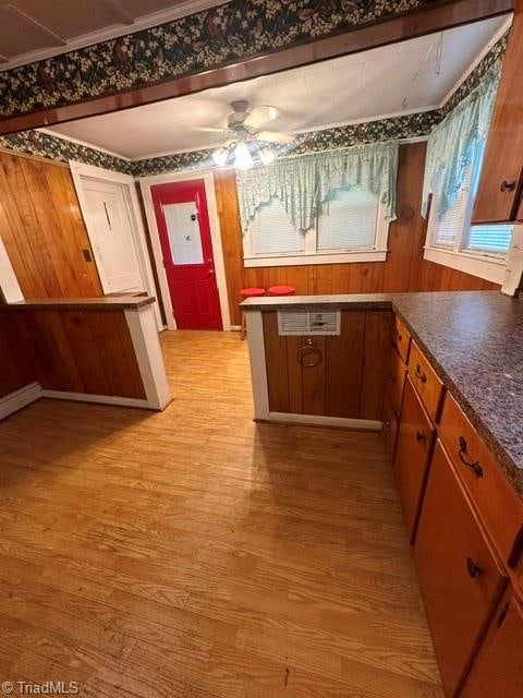 kitchen featuring ceiling fan, light hardwood / wood-style flooring, and ornamental molding