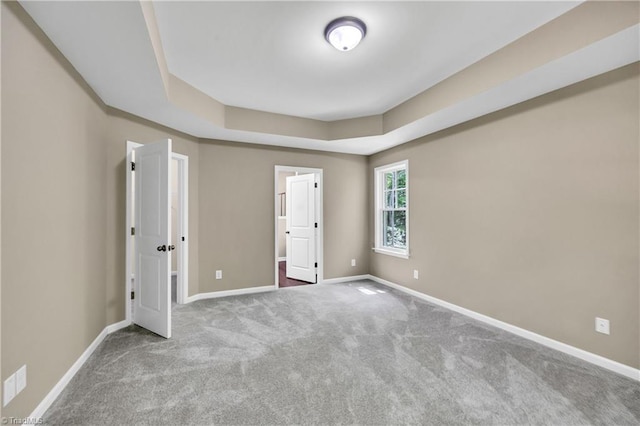 unfurnished bedroom featuring carpet floors and baseboards
