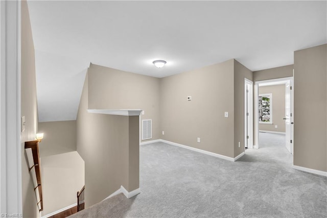 unfurnished room with carpet and baseboards