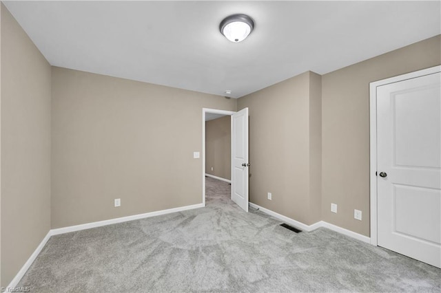 unfurnished bedroom featuring baseboards and carpet