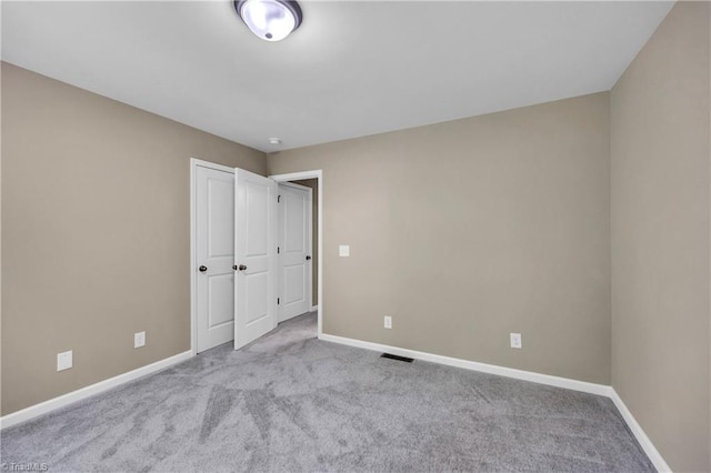 unfurnished bedroom featuring baseboards and carpet